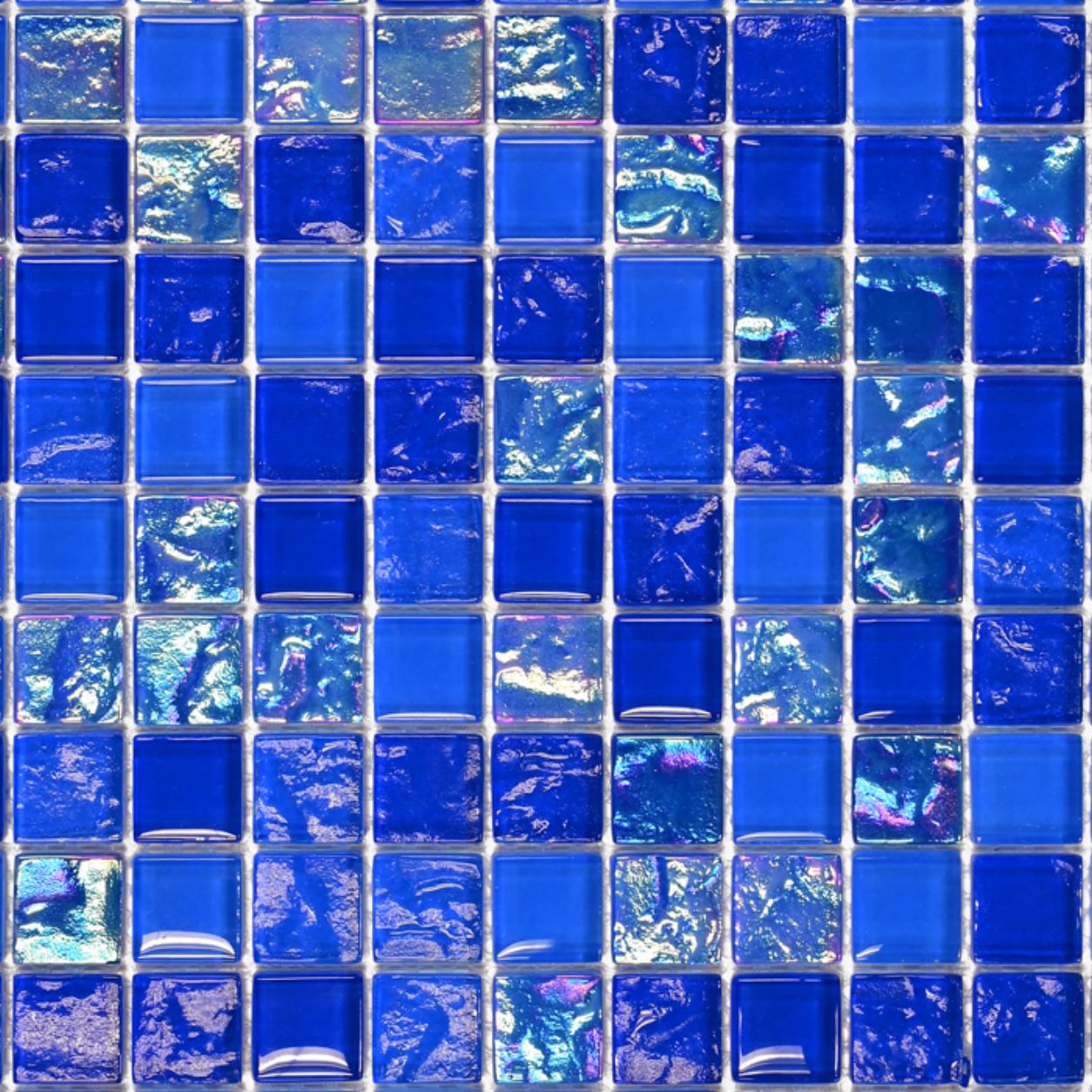 Macro close-up of Cobalt Blue iridescent glass mosaic showing deep cobalt square chips with a pearly sheen.