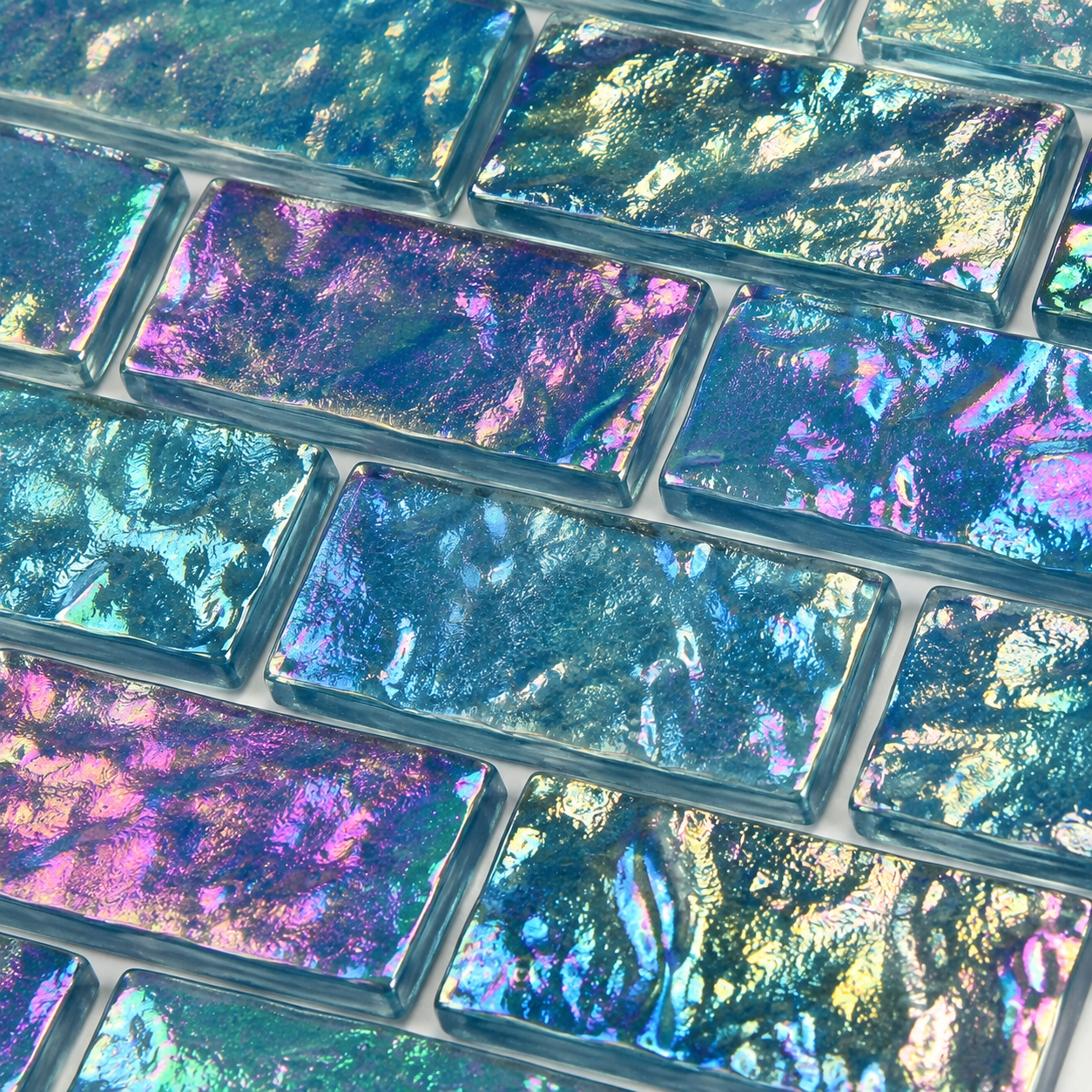 Macro close-up of Peacock Teal iridescent glass mosaic showing teal, purple and green colour shift.