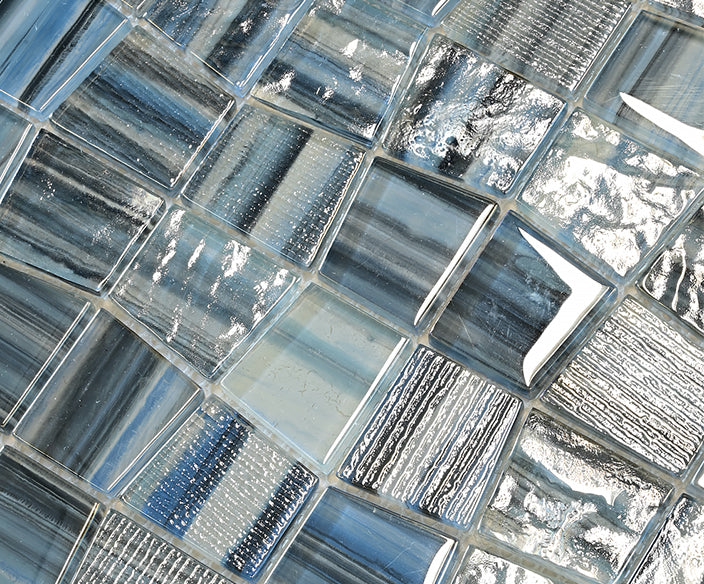 Macro close-up of Textured Ocean Blend glass mosaic showing glossy blue, silver and white chips.