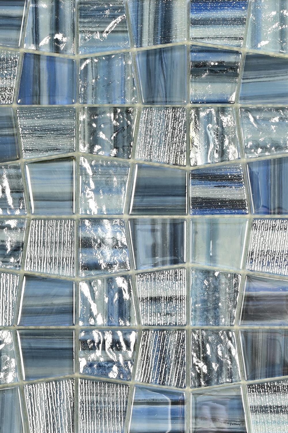Mosaic pattern of glass tiles in blue and silver tones