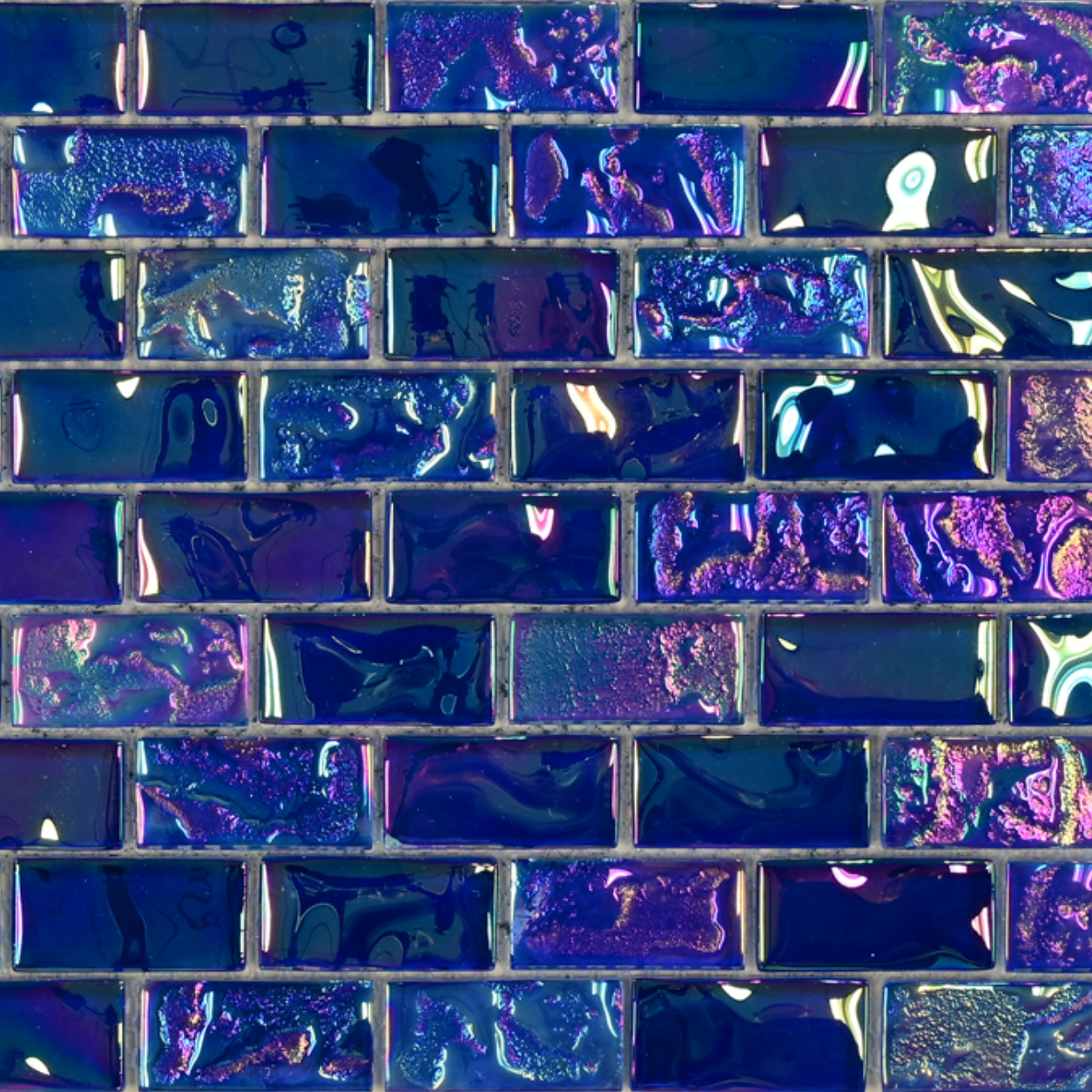 Macro close-up of Sapphire Indigo iridescent glass mosaic showing indigo and violet colour shift.