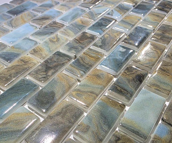 Macro close-up of Earthstone Green recycled glass mosaic showing glossy olive, sage and cream chips.