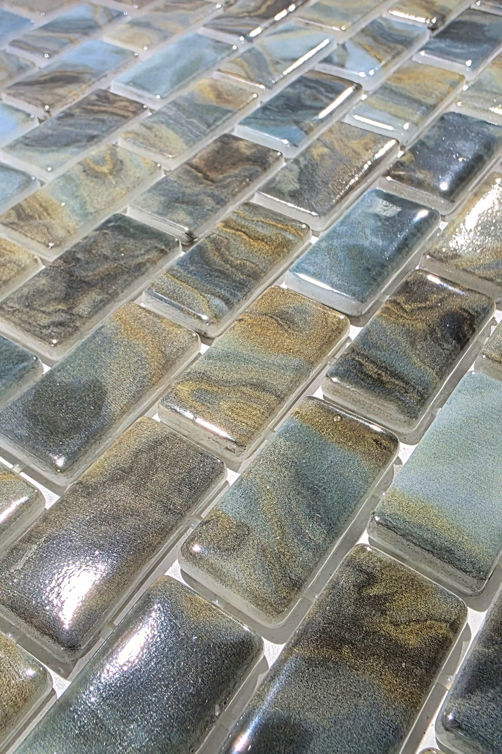 Close-up of Earthstone Green recycled glass mosaic tile showing glossy olive, sage and cream chips.